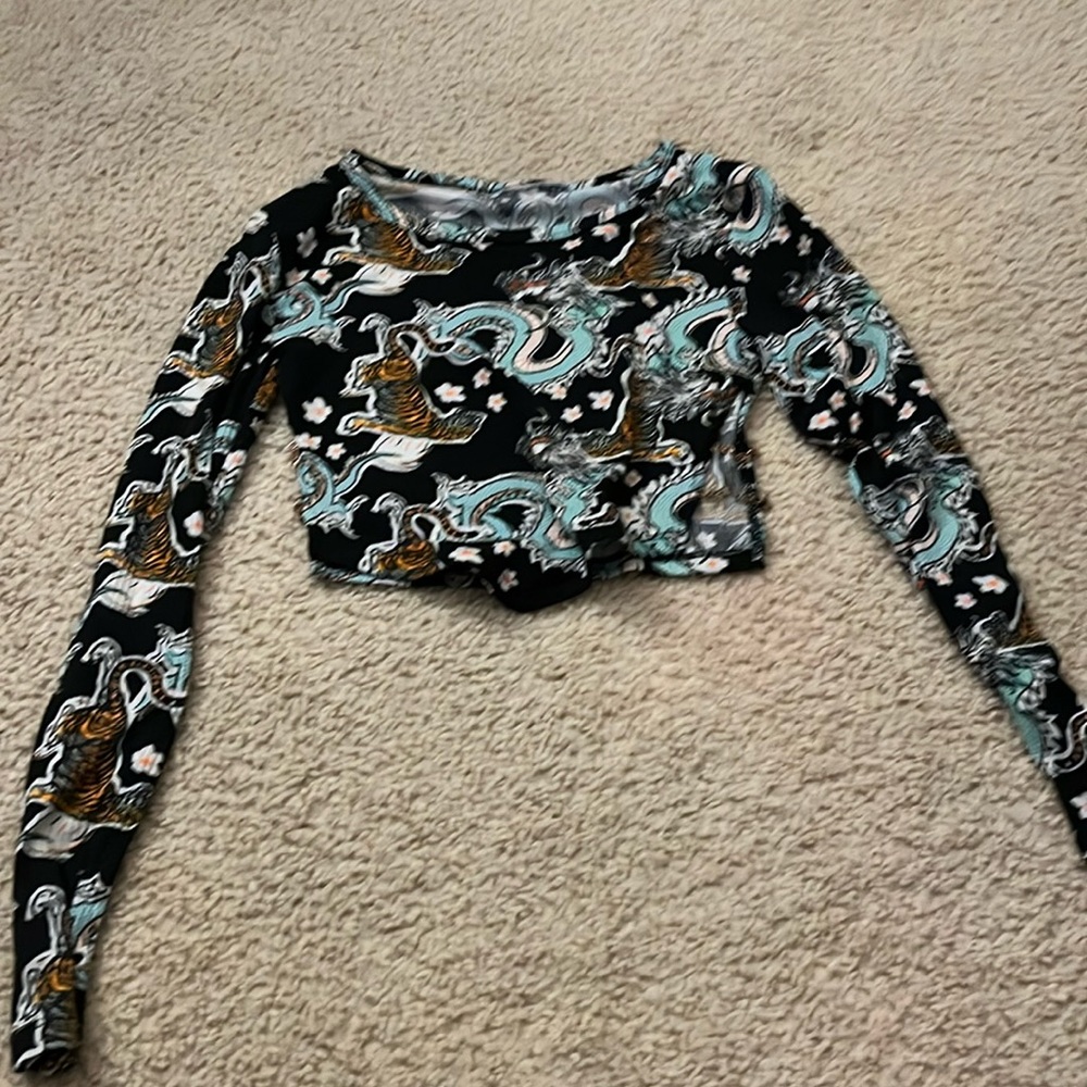 Black long sleeved top with Chinese tiger and dragon print.